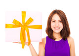 closeup of happy young woman holding a gift box 
