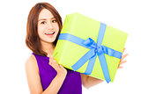 closeup of happy young woman holding a gift box