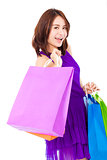 smiling young woman holding shopping bag