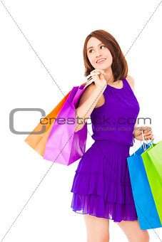 smiling young woman holding shopping bag