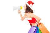 Christmas santa woman using a megaphone with gift bags