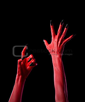 Red spooky devil hands with black nails, real body-art 