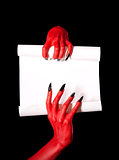 Red devil hands holding blank paper scroll