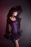 Gothic girl in purple Victorian outfit   