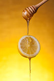 Honey flowing on lemon slice 