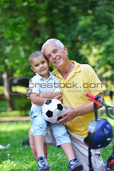 happy grandfather and child in park