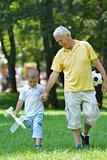 happy grandfather and child in park