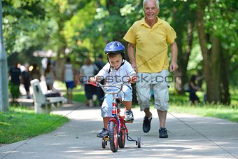 happy grandfather and child in park