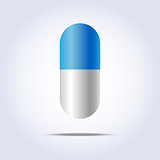 Blue and white pill on white background