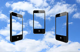 three modern mobile phones on the sky