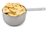 Dried banana chips in a cup measure