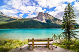Scenic view of mountain lake and wooden bench