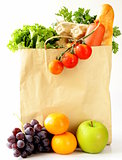 paper shopping bag full of products (bread, eggs, sausage, fruit and vegetables)