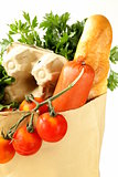 paper shopping bag full of products (bread, eggs, sausage, fruit and vegetables)