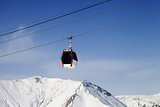 Gondola lift and snowy mountains