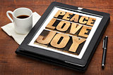 peace, love and joy on a tablet