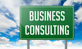 Business Consulting on Highway Signpost.