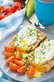Sandwich with poached egg and cherry tomatoes