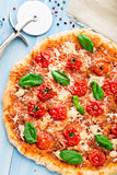 Pizza with cherry tomatoes and basil
