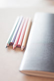 Color pencils with black notebook