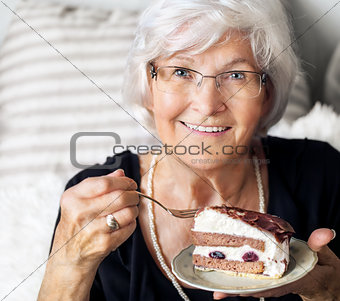 Senior woman enjoying cake