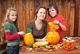 Kids carving jack-o-lanterns for Halloween