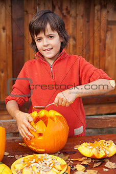 Boy carving his jack-o-lantern