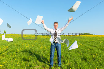 successful businessman threw papers in the field