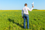 manager with papers out in the field