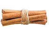 cinnamon sticks tied with a rope on a white background