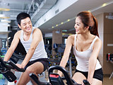man and woman talking in gym