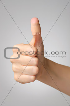 Plaster on female thumb