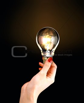 Female Hand Holding Light Bulb