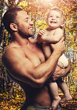 Loving father with daughter against forest background