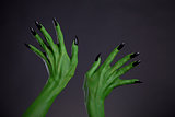 Green monster hands with black nails, real body-art 