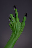 Green witch hand with black nails, real body-art 