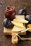cheese board plate with plums jam and fresh fruit
