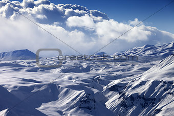 Snowy sunlight plateau and blue sky with clouds