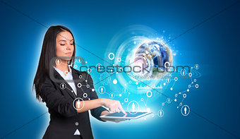Women using digital tablet and Earth with graphs