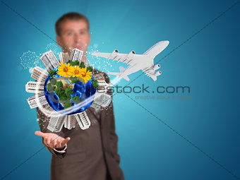 Businessman holding earth with buildings