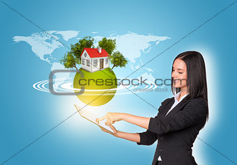 Women using digital tablet and Earth with house