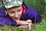 girl collect brown cap boletus on forest