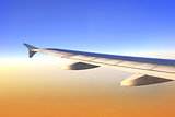 Wing of aircraft in sunrise light