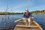 paddling canoe on a lake