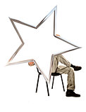 man sitting on a chair and holding a five-pointed star