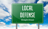 Local Defense on Highway Signpost.