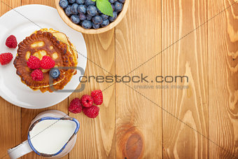 Pancakes with raspberry, blueberry and milk