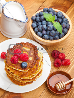 Pancakes with raspberry, blueberry, milk and honey syrup