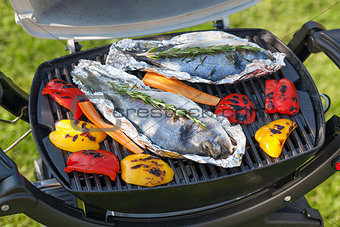 Fresh dorado fish and bell pepper grill cooking