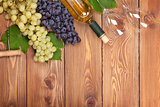 White wine bottle and bunch of grapes